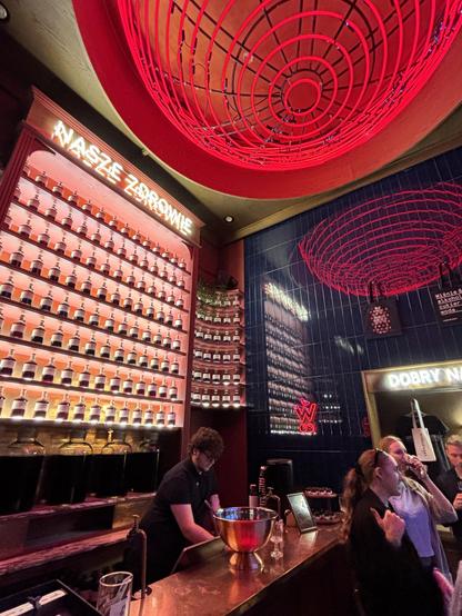 Bar, behind which are high shelves full of cherry vodka bottles.