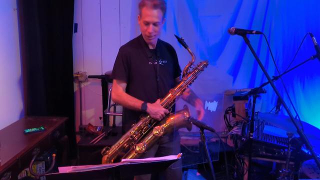 Person holding a baritone saxophone