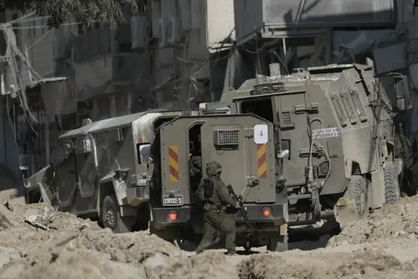 Members of Israeli occupation forces patrol a street during a raid in the West Bank refugee camp of Nur Shams. Thursday August 29, 2024. (AP)