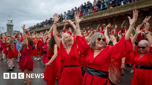 Hundreds of Kate Bush fans came together today wearing red floaty dresses on Folkestone's Harbour Arm to dance to her most iconic song, Wuthering Heights on the 20th of July 2025 in Folkestone, United Kingdom. 