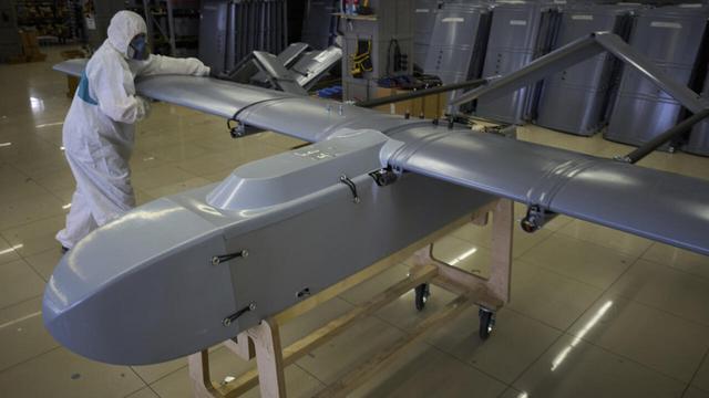 A worker inspects a combat drone at Fire Point's secret factory in Ukraine on Monday, 18 August 2025. | © Efrem Lukatsky, AP