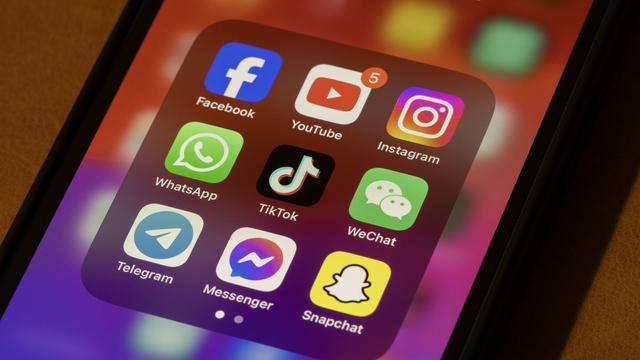 An iPhone with a number of social media apps.