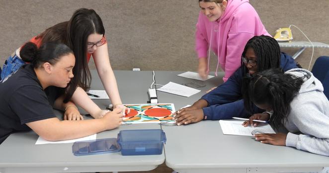 Paducah Tilghman High School students measure angles on display in quilt during a field trip to the National Quilt Museum.