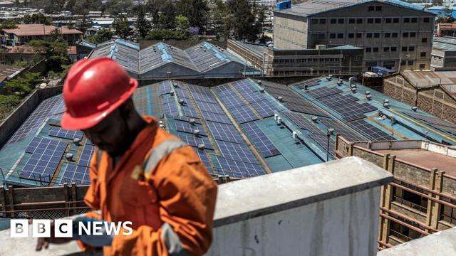 A technician from CP Solar works on the installation of solar panels at the roof a partially solar-powered factory in the industrial area of Nairobi. Renewable energy sources generate over 80 percent of Kenya's electricity.