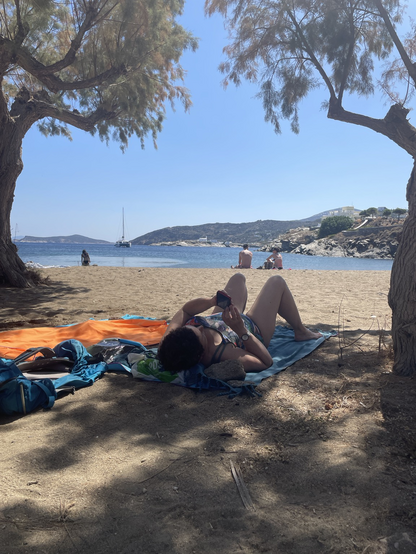 My wife relaxing under the trees on Fasolou beach.