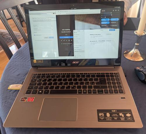 Picture of the laptop in question effortlessly running Debian testing, Trixie, Live with full hardware support.