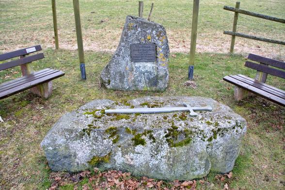 Monument at the site of the free court in Assinghausen with a sword on the judgement stone.
