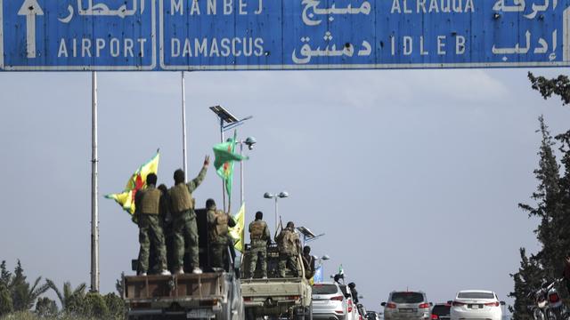 Kurdish fighters leave northern city in Syria as part of deal with central government