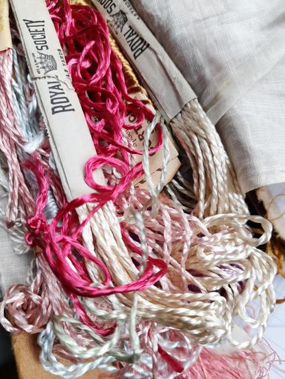 A collection of old, very glossy embroidery yarn with some paper envelopes "Royal Society".