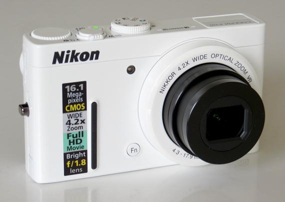 Image of a white Nikon camera with a 16.1 megapixel CMOS sensor, featuring a 4.2x optical zoom lens and a bright f/1.8 aperture. The camera is positioned at an angle, showcasing its controls and branding.

Not my photo, it is taken from the internet. All right’s acknowledged.