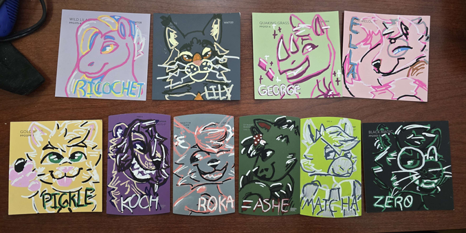a bunch of doodle badges drawn on various colors of paint swatches, theres a horse, some cats, two lemurs, a ferret and a rhino