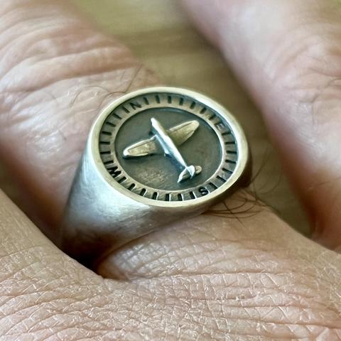 My new aviation silver ring with a compass and a small spitfire model on it.