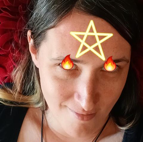 Picture of me lying on my rose pillows, my eyes covered with fire icons and a glowing line art 5 pointed star on my forehead.