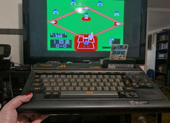 A shot showing the game on in the background with me holding my MSX2 up with the game inserted