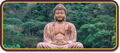 a big gold buddha in the middle with a green forest, slightly out of focus in the back ground.