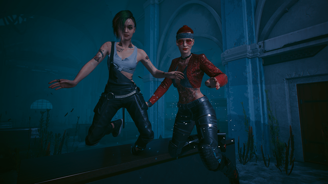 A picture of two female persons, floating under water in a flooded church, the blue hue of the light gives it a dreamy or Caribbean feel, you can see old church banking a cut of door on the right sideone is Judy