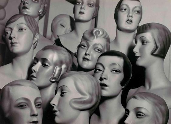 Close-up black and white image of multiple Art Deco style mannequin heads.