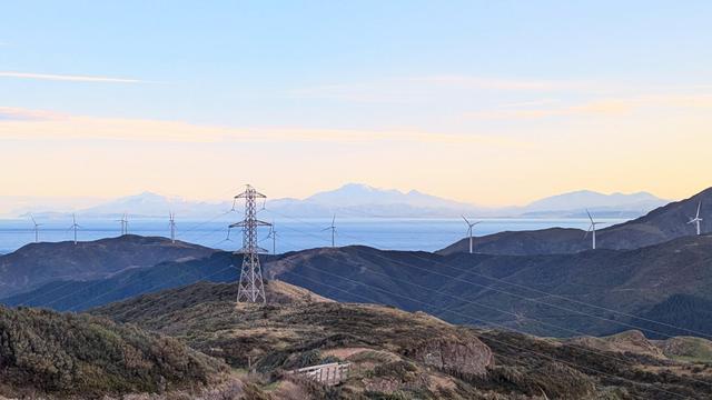 Looking south towards the Kaikoura ranges which have a little fresh snow. Barren hills and power pylons in the foreground.