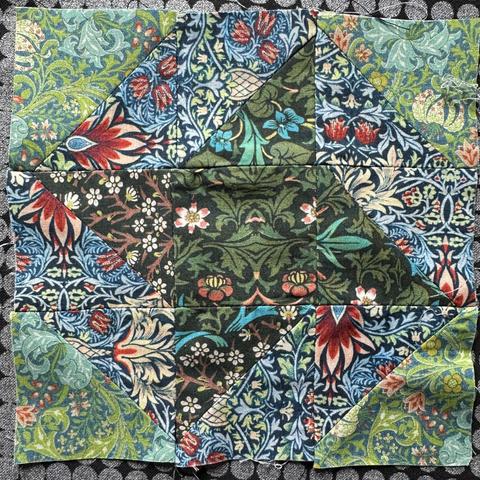 A 9 section block for quilting. It’s made up of half square triangles and there main motif is a friendship star. The fabrics used have a lot of patterns going on. William Morris inspired patterns. Like it’s flowers and birds everywhere.