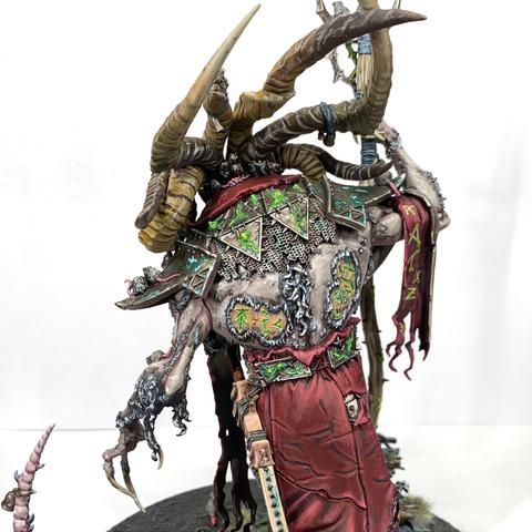 Huge, multi-horned rat demon walking upright over green-glowing ruins surrounded by skittering rats. He carries a staff, has a sword at his hip, and wears red robes and a sash. All are glowing with green runes, including Vizzik’s back.
