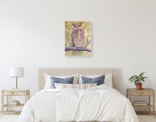 A watercolor painting of an owl is hung on a wall over a bed, with two nightstands on each side of bed.