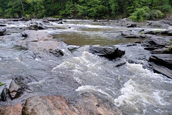 A creek view with a lot of water cascading down rocks