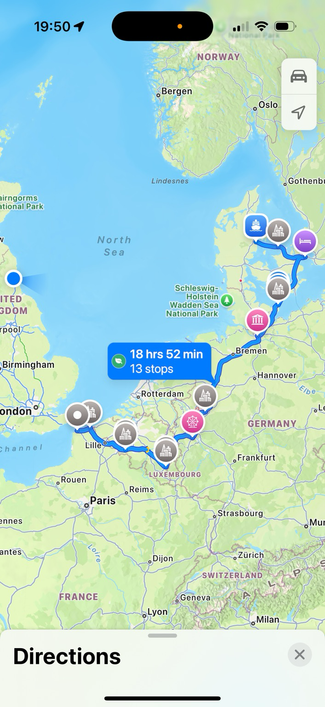 Screenshot of Apple Maps showing a European route from the Eurotunnel port in Calais, France through Dunkirk, Mons, Bastogne, Northern Luxembourg, via Phantasialand theme park near Cologne, Bremen, Hamburg, the ferry from Germany to Denmark heading to Copenhagen. Home town of Newcastle upon Tyne in north east England is highlighted.