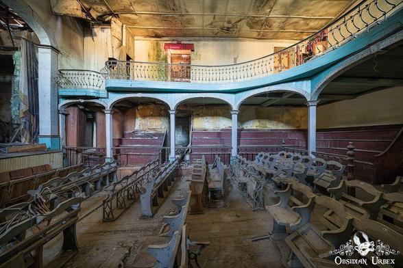 abandoned theater with folding wooden chairs