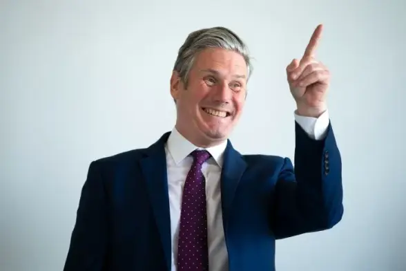 Keir Starmer smiling and pointing