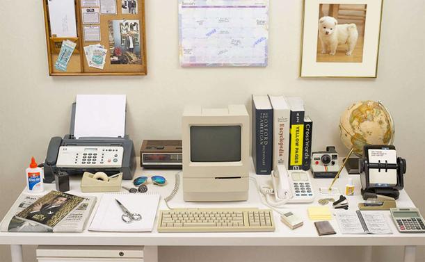 Photograph of the Evolution Of The Desk Video, showing how many office tools and home devices have been replaced by the home computer.