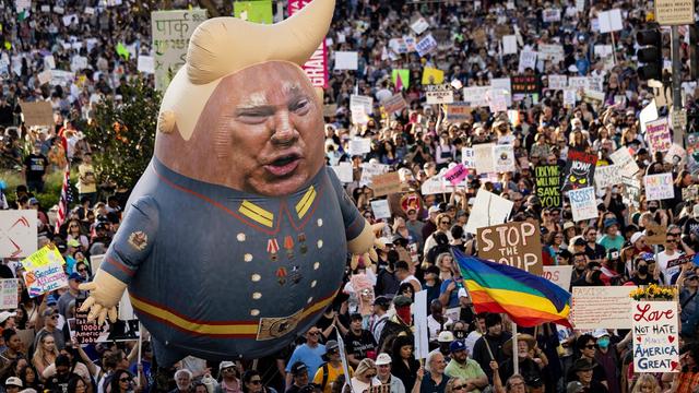 A large balloon with an image of President Donald Trump above protesters during the nationwide "Hands Off" protests against Trump and Elon Musk in downtown Los Angeles on April 5, 2025. (Photo by ETIENNE LAURENT/AFP via Getty Images)