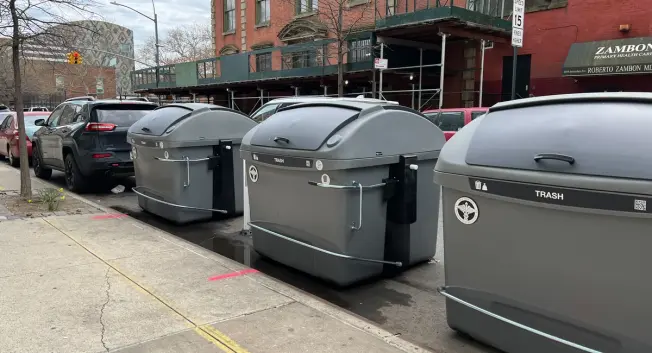 New garbage bins on the street in Harlem.