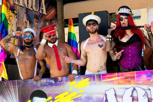Four gay men looking watching a PRIDE event