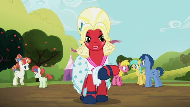 A screenshot from the episode where Big Mac dresses up as a fancy southern belle in her cute lil dress and big fancy blonde wig.