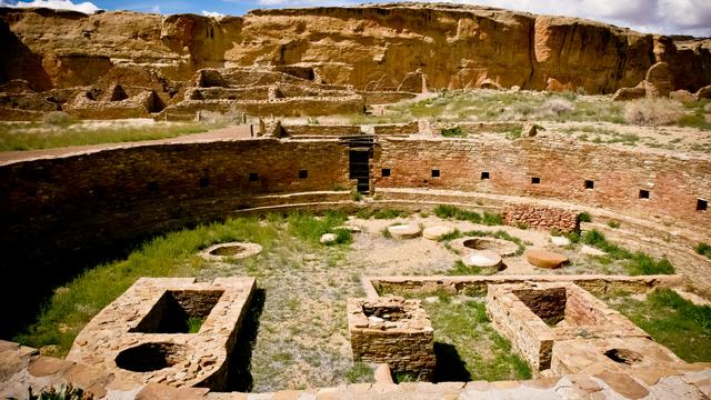 Image of a large, circular, below-ground area surrounded by very finely crafted stone walls. Other ruins are in the background. Image of a large, circular, below-ground area surrounded by very finely crafted stone walls. Other ruins are in the background.