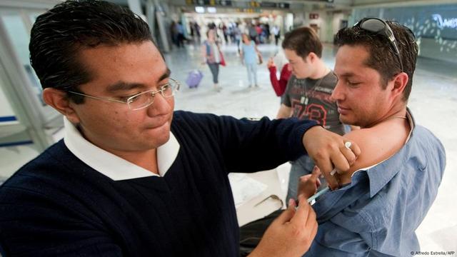 A passenger leaving Mexico is vaccinated against measles at Benito Juarez International Airport in Mexico City
