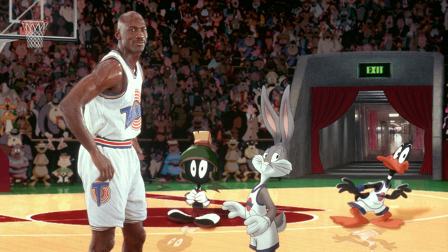 A still from the film Space Jam featuring Michael Jordam, Marvin the Martian, Bugs, and Daffy on a basketball court.