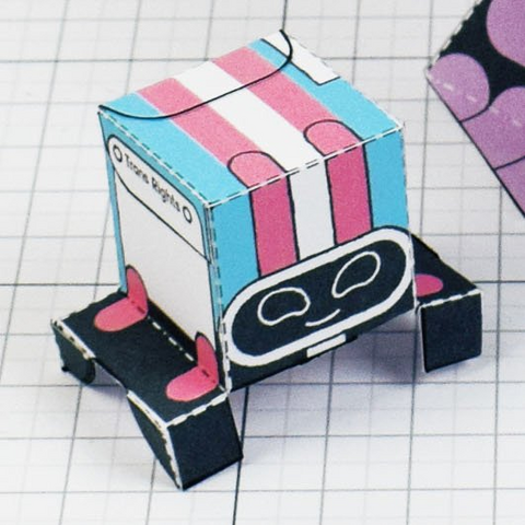 A photo of a papercraft depicting a small robot that is pink, blue and white 