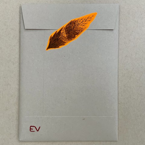 This is the back of the envelope, and it has an illustrated leaf sticker to seal it shut. There are also embroidered initials at the bottom. 