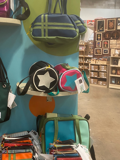 Vending booth display of brightly colored vinyl purses and bags by Nakatsu by JNA Designs