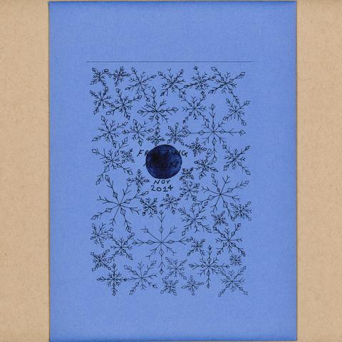 The front of an envelope which has a printed design of snowflakes for the freezing moon in November.