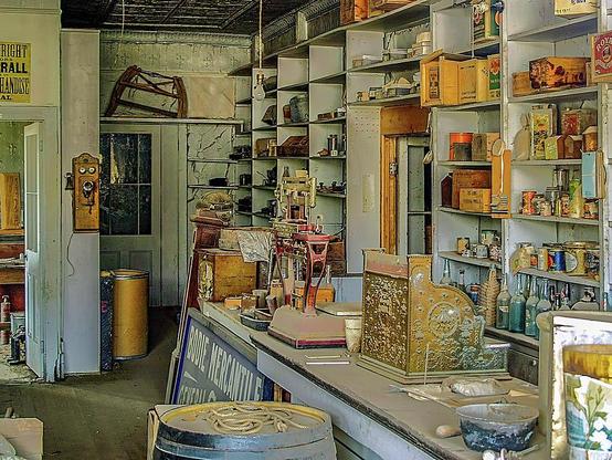 Bodie Mercantile

Captured at the Bodie State Historic Park. This is an image, a look into the past, of the interior of the Bodie Mercantile.
This image is basically a time stamp of the early 1930's. After easy gold was gone, the Bodie Railroad shut down and then with 2 major fires destroyed most of the town, things shut down.
Inside this shop are old fashion, wooden telephone on the far wall. The old cash register sits on the counter. 
Behind the counter there are still a number of canned goods, bottles, and tins holding various items.
All of these items are covered with nearly 100 years of dust.