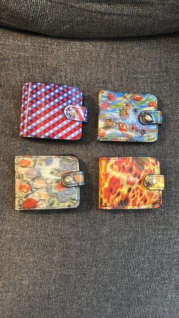 Four lenticular vinyl snap billfold wallets I made. Stars and Stripes, insects, money, and fire prints.