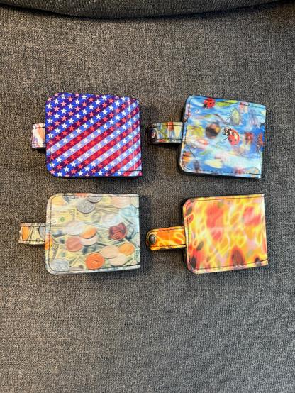 Back side of lenticular vinyl snap billfold wallets I made. Stars and Stripes, insects, money, and fire prints.