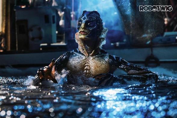 The creature from the Shape of Water appears out of the ocean surrounded by boats