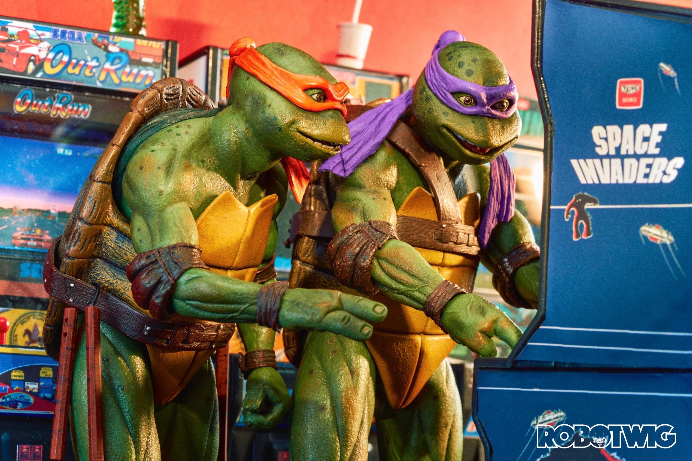 Michelangelo and Donatello play Space Invaders in an arcade looking very excited