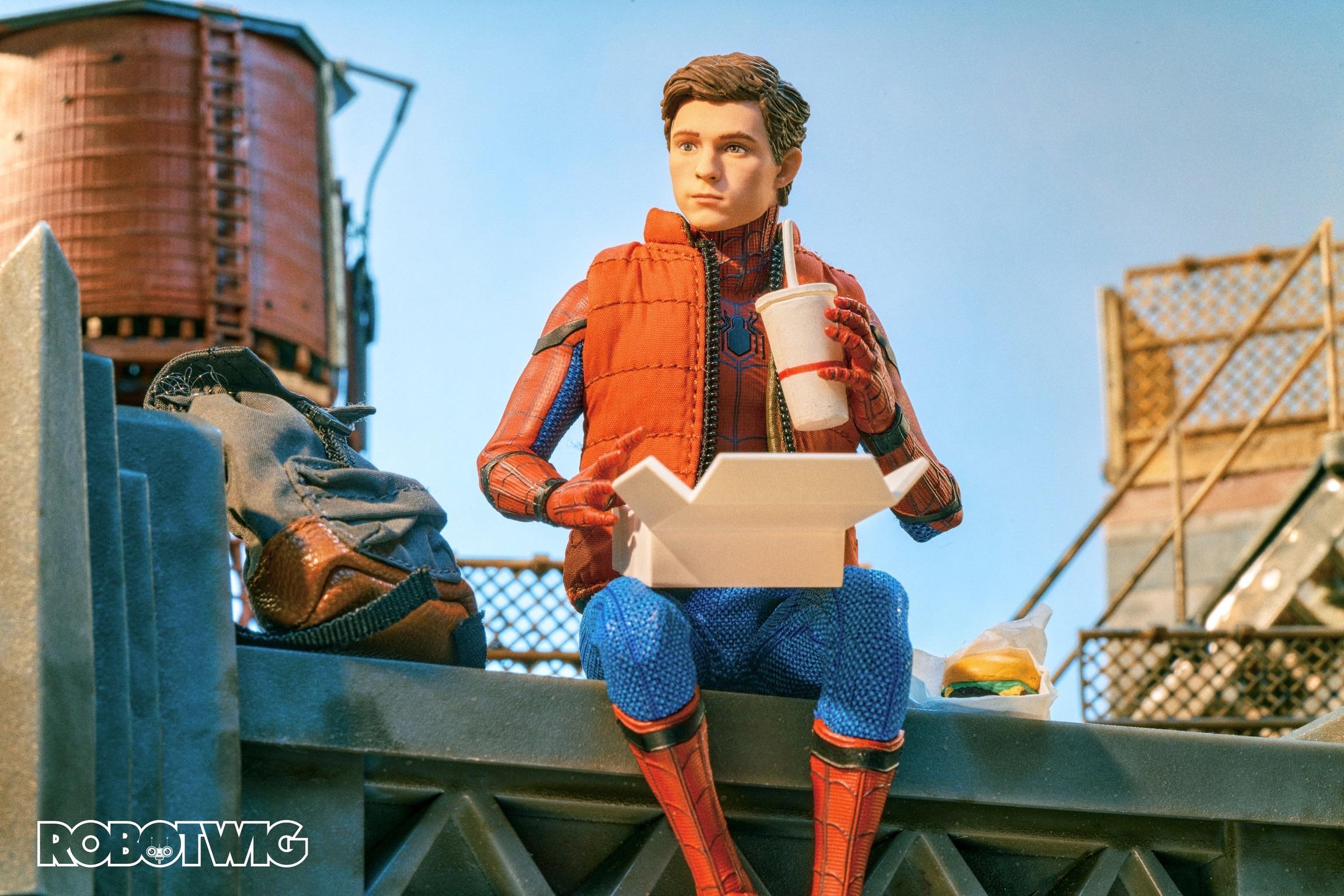 Peter Parker sits atop a building having lunch. He keeps his eye out for any crimes going on