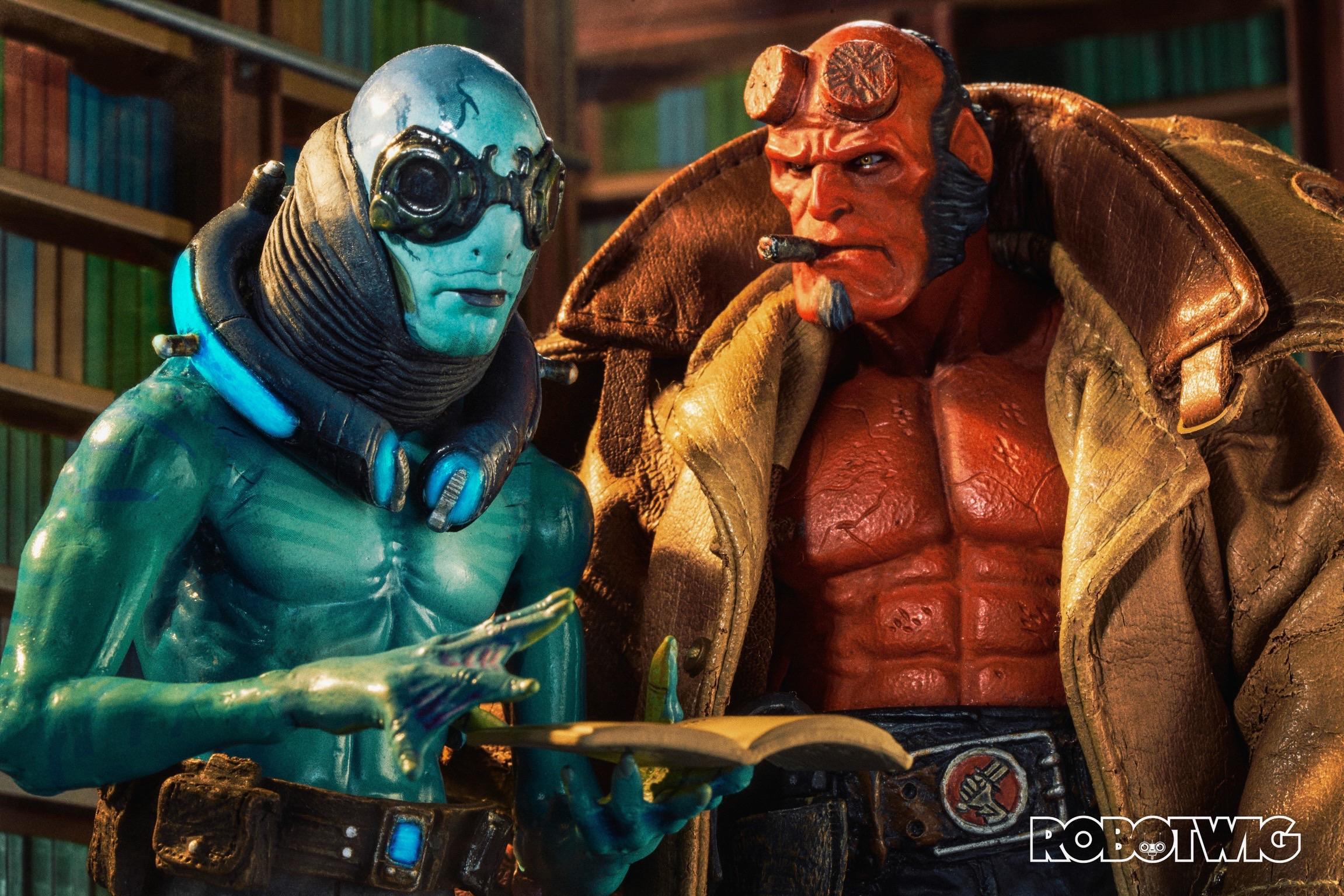 Abe Sapien reads from an old book in a library. Hellboy looks at him impatiently