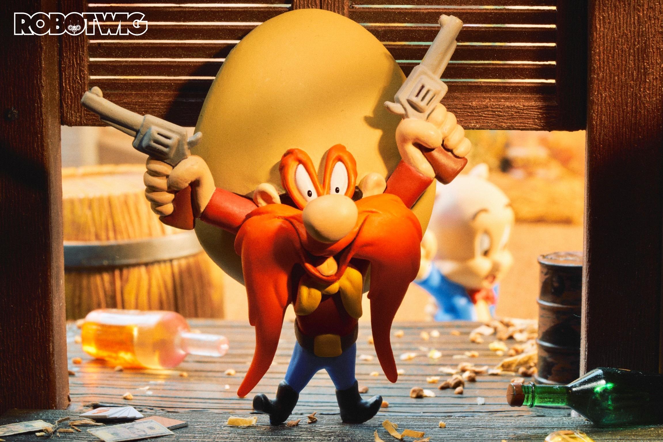 Yosemite Sam walks into a Saloon toting his guns.