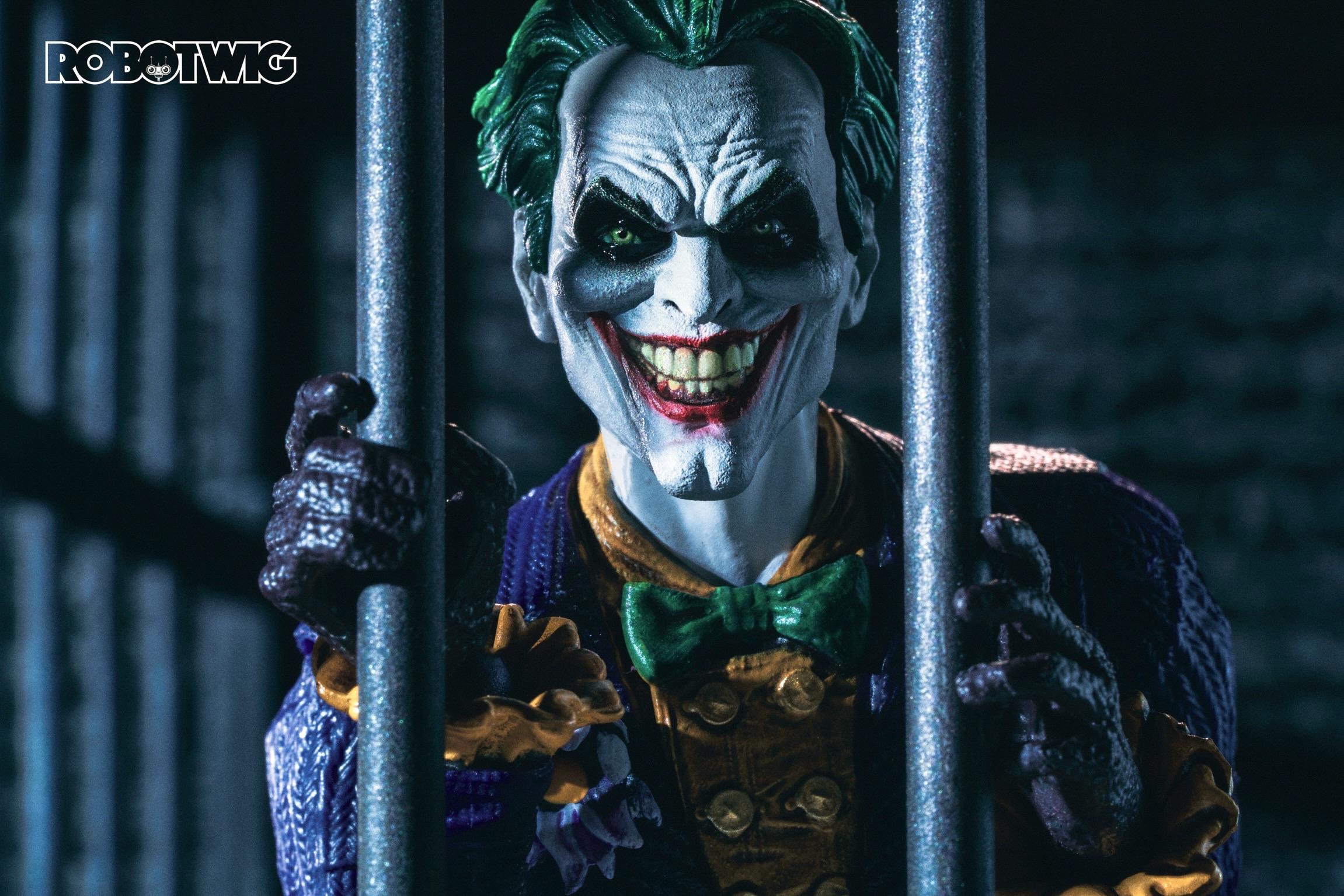 The Joker peers through prison bars with a menacing grin on his face